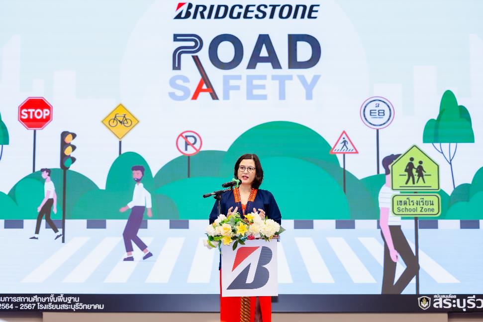 A person standing in front of a podium with flowers Description automatically generated